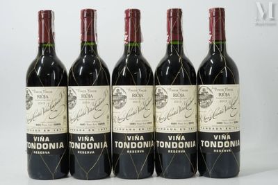 six bottles of wine are lined up on a white surface