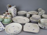 many different types of dishes and cups on the table