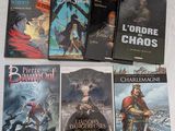 six romans fantastiques français posés sur une surface blanche