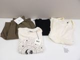 three pairs of t - shirts on a table with tags on them