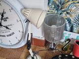 a clock and darts on the floor next to a wall