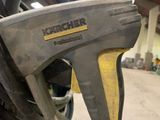 a close up of a yellow and black gun in a warehouse