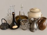 many different types of vases and jars on the table