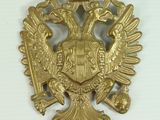 an image of a gold eagle with a crown on it ' s head