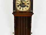 a clock that is hanging on the wall with angels on it
