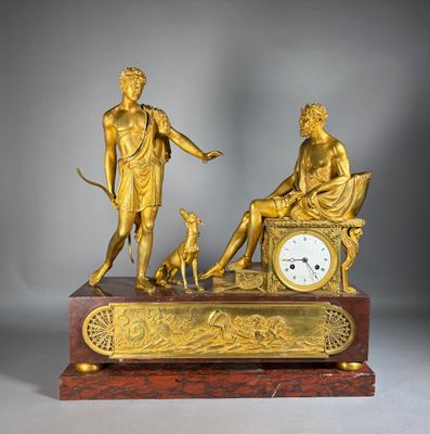 a gold statue of a man and a woman sitting on a bench with a dog