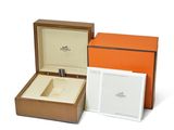 an orange box with a watch inside of it and a white box with a watch inside of it