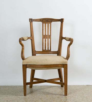 Fauteuil en merisier mouluré sculpté à décor de nœuds de rub…