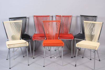 four chairs are lined up in a row on a gray surface