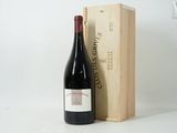 a bottle of wine sitting next to a wooden box