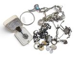 a small box with a bunch of jewelry on it