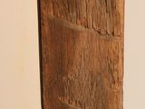 a large piece of wood that is leaning up against a wall