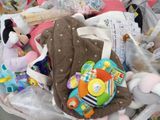 a basket full of toys and stuffed animals in it