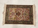 an old rug with a bird on it is laying on the floor