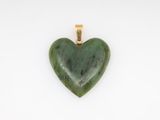 a green jade heart pendant on a white background