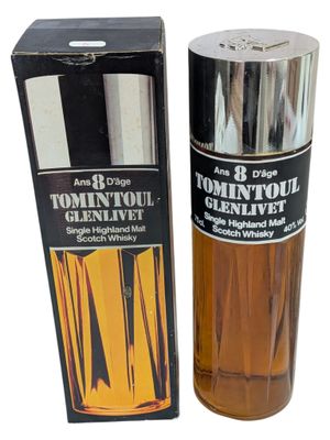 an image of a bottle of cologne next to a box of cologne