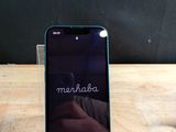 someone is taking a picture of a cell phone on a wooden table
