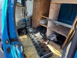 a blue van that has a shelf in the back of it