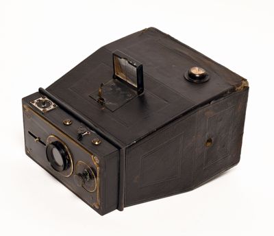 an old camera that is sitting on a white surface