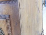 a wooden cabinet that has a metal handle on it