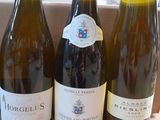 three bottles of wine sitting on a table next to each other