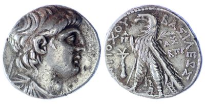 a silver coin with an image of a woman and a bird on it