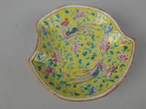an image of a yellow bowl with birds and flowers on it