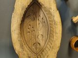a wooden object on the wall next to other items