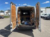 a white van with a door open in a parking lot