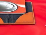 a wallet with a book on top of it on a table