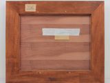 a picture of a wooden frame with a piece of paper taped to it