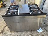 a man standing in front of a stove with two pans on it