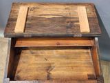a wooden box with a drawer on top of it