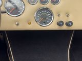 a dashboard of a car with a clock and a steering wheel