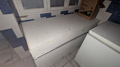 an image of a kitchen with a white refrigerator and a window