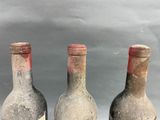 three bottles of wine sitting next to each other on a table