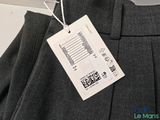 the label is attached to the pants on the hanger