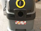 an image of a vacuum cleaner machine in a garage