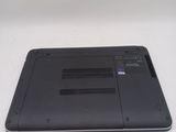 the back of a laptop with a black cover on a white surface