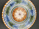 a plate with a design on it sitting on a table