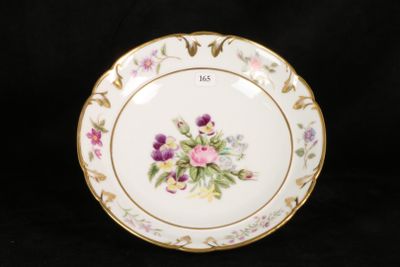 a plate with flowers painted on it on a black background