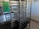 a metal rack with trays on it in a kitchen