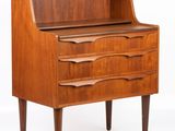 a wooden desk with three drawers and a shelf on top of it