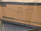 a cardboard box with a fan on top of it