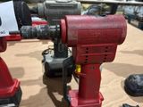 two electric tools on a table in a warehouse