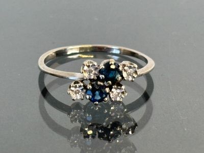 an image of a ring with blue and white diamonds