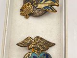 two pins that are in a box on a table