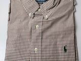 a close up of a brown and white shirt on a table