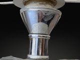 a close up of a silver object with a straw in it
