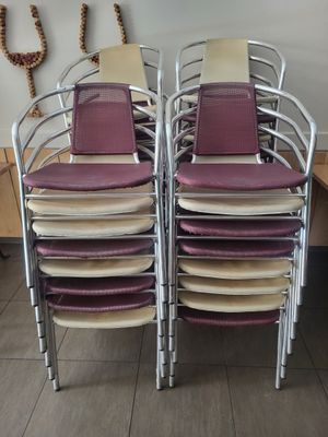several chairs are stacked on top of each other in a room